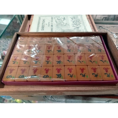 75 - A beautiful carved box comprising of a mahjong set