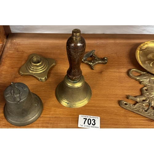 703 - A selection of brass including bells & chamber candlestick etc.