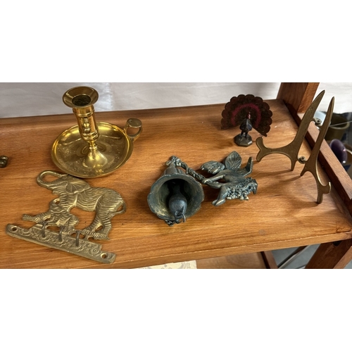 703 - A selection of brass including bells & chamber candlestick etc.