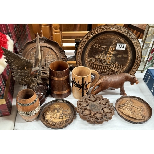 823 - A selection of wooden items including wall plaques & tankards etc.