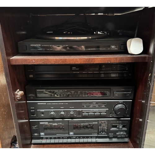 841 - A dark wood music cabinet with bevelled glass door