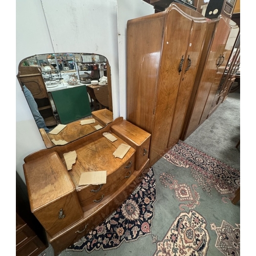 850 - A 1930's walnut veneered bedroom suite comprising of 2 wardrobes and a dressing table