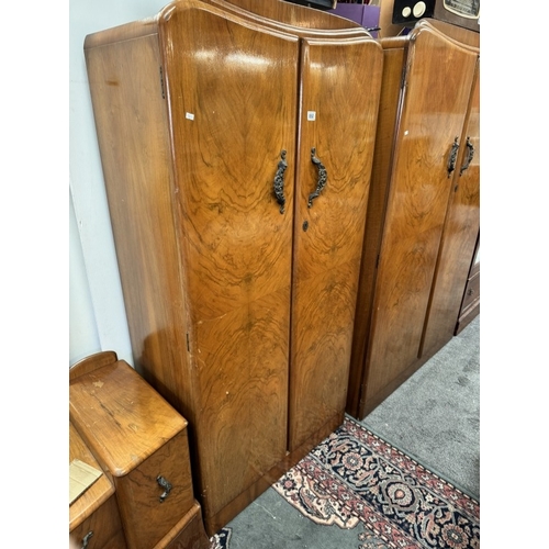 850 - A 1930's walnut veneered bedroom suite comprising of 2 wardrobes and a dressing table