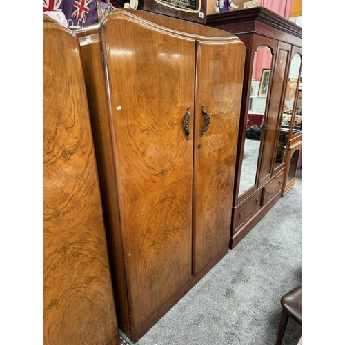 850 - A 1930's walnut veneered bedroom suite comprising of 2 wardrobes and a dressing table