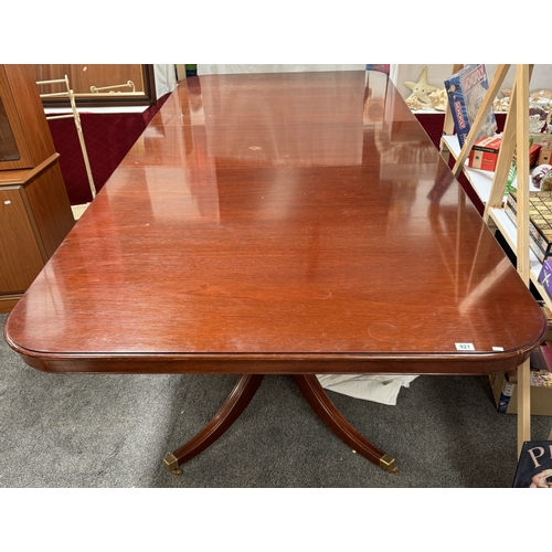 921 - A Large mahogany extending dining table on two centre columns.