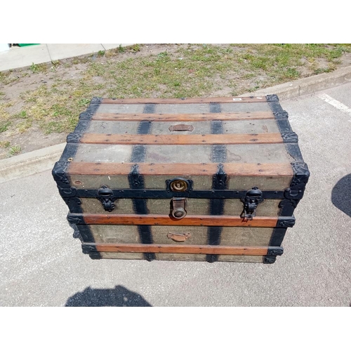 958 - A large wood bound steamer trunk