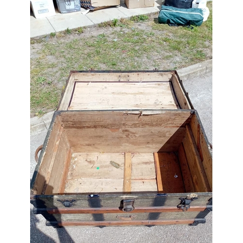 958 - A large wood bound steamer trunk