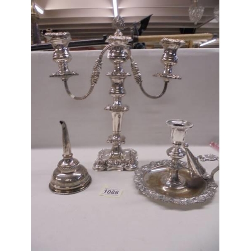 1088 - An ornate silver plate candelabra, a chamber candlestick and a wine funnel.