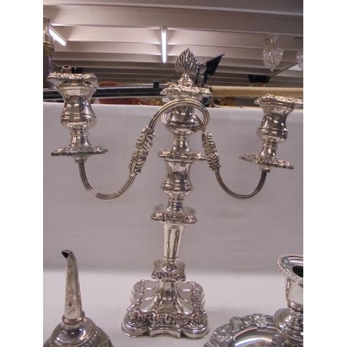 1088 - An ornate silver plate candelabra, a chamber candlestick and a wine funnel.