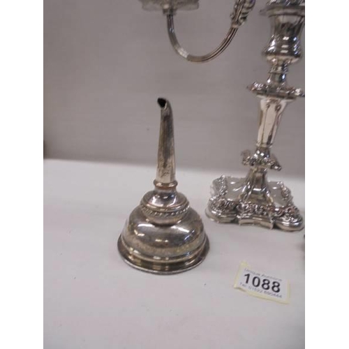 1088 - An ornate silver plate candelabra, a chamber candlestick and a wine funnel.