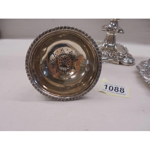 1088 - An ornate silver plate candelabra, a chamber candlestick and a wine funnel.