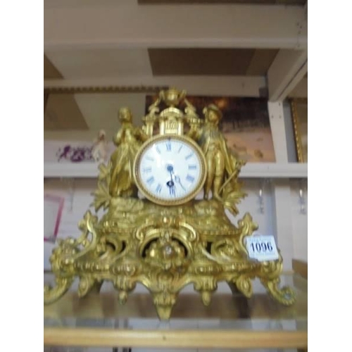 1096 - A gilded mantel clock surmounted two figures.