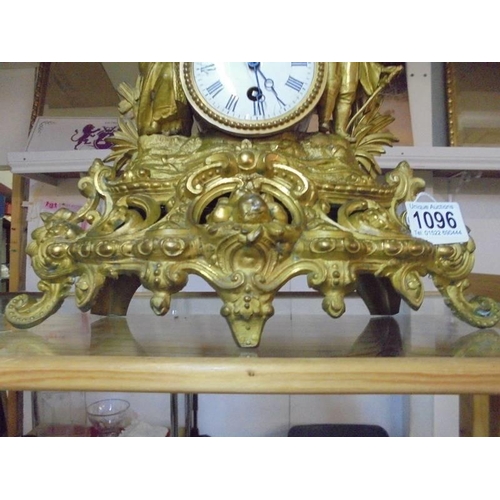 1096 - A gilded mantel clock surmounted two figures.