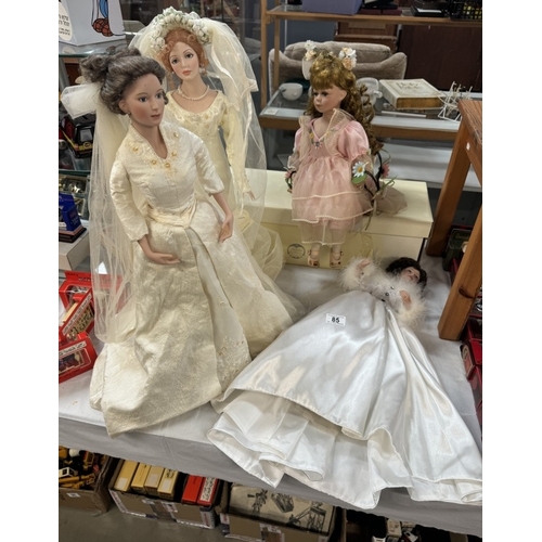 85 - 2 Bridal porcelain dolls & 2 others (One of which is on a swing, only one boxed)