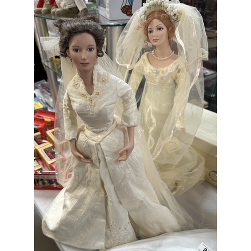 85 - 2 Bridal porcelain dolls & 2 others (One of which is on a swing, only one boxed)