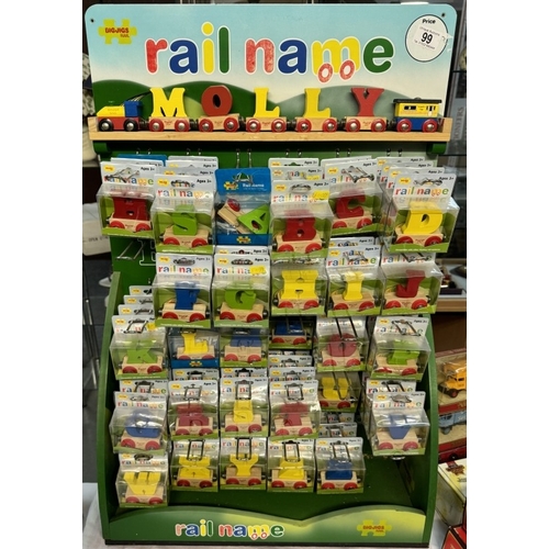 99 - A shop display stand with a quantity of wooden letters etc by Big Jigs Rail