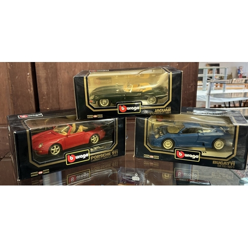 217 - 3 Boxed Burago 1/18 scale cars including Jaguar e-type, A Maistro Volkswagen beetle & Ford Street KA