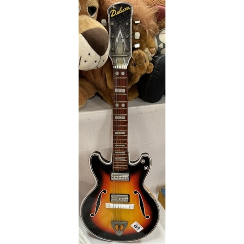 499 - A 1960s Japanese tinplate Gibson style guitar by TN Nomura. Length 71cm