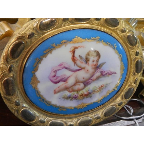 1814 - A French gilded mantel clock surmounted cherub figure and with Sevres porcelain panels, COLLECT ONLY... 