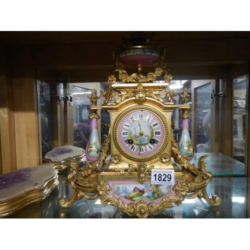 1829 - A French gilded mantel clock with Sevres panels, in working order, COLLECT ONLY.