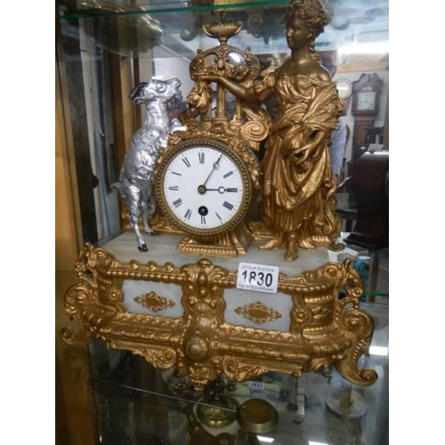 1830 - A French gilded mantel clock with goat and figure atop, in working order, COLLECT ONLY.