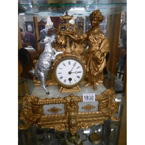 1830 - A French gilded mantel clock with goat and figure atop, in working order, COLLECT ONLY.