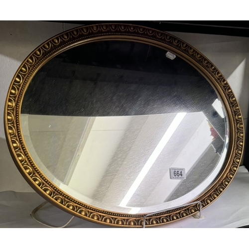 664 - A vintage oval gilt framed bevel edged mirror