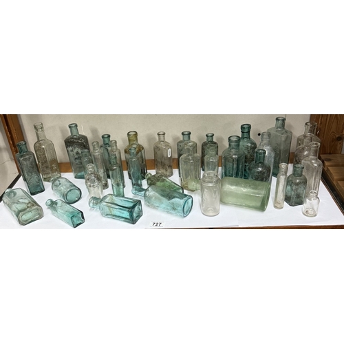 727 - A shelf of vintage glass bottles