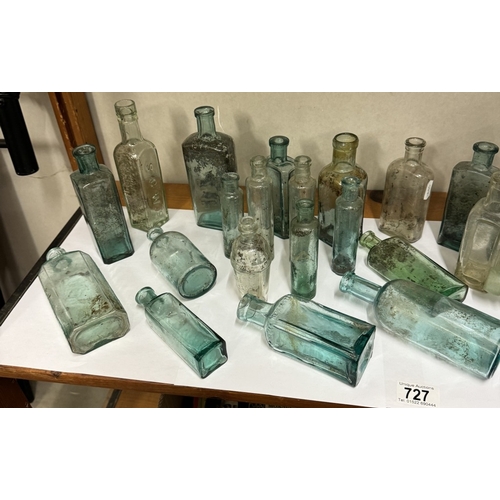 727 - A shelf of vintage glass bottles