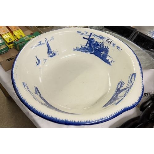 882 - A large East Anglia empire ware blue and white pottery wash bowl decorated with boats and windmills