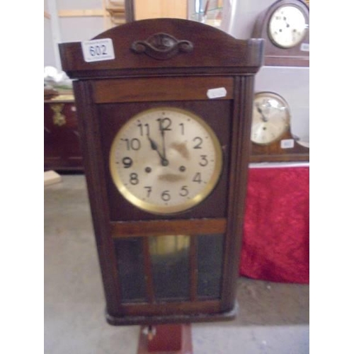 602 - An oak 8 day wall clock, in working order, COLLECT ONLY.