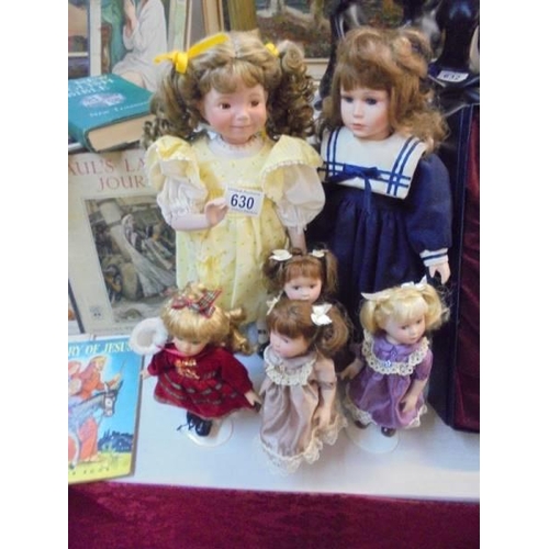 630 - Four small and two medium porcelain collectors dolls.