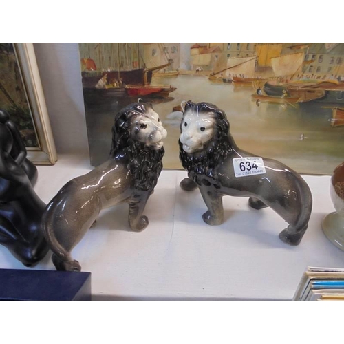 634 - A pair of Staffordshire lions.