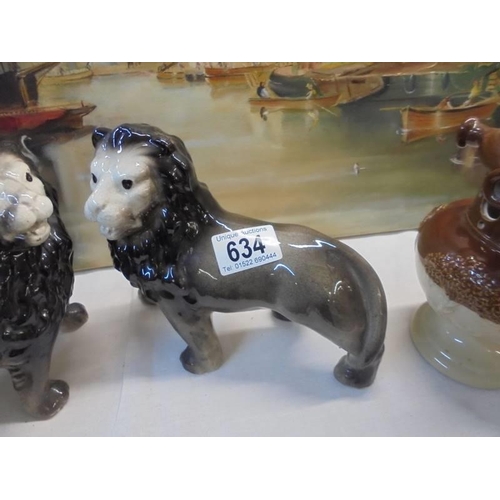 634 - A pair of Staffordshire lions.