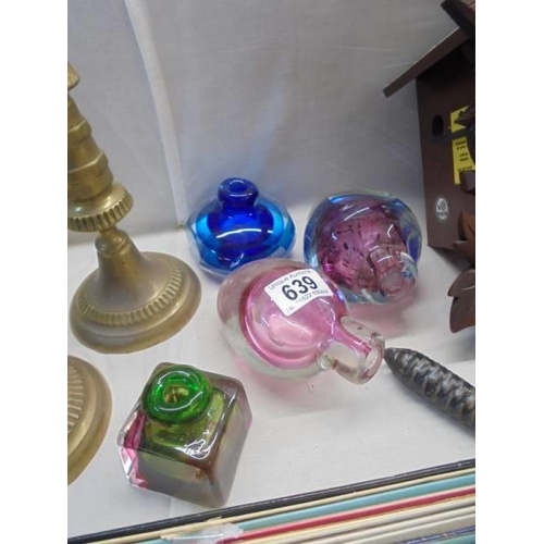 639 - Two coloured glass inkwells and two other coloured glass items.