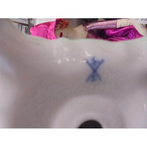 645 - A porcelain cherub candlestick with crossed swords mark.