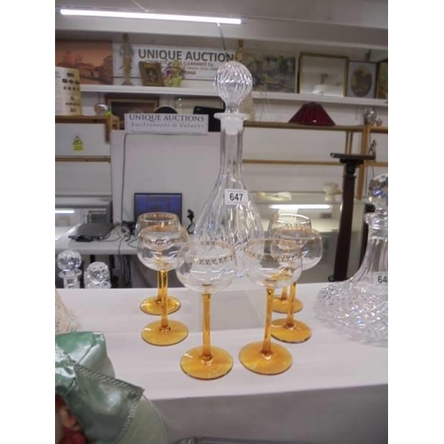 647 - A cut glass decanter with six amber glass stemmed glasses. COLLECT ONLY.