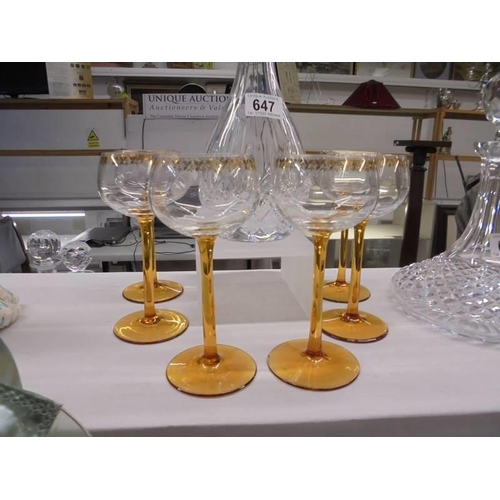 647 - A cut glass decanter with six amber glass stemmed glasses. COLLECT ONLY.