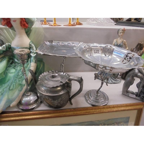 649 - Two metal cake stands with figural bases, a candlestick and a teapot.