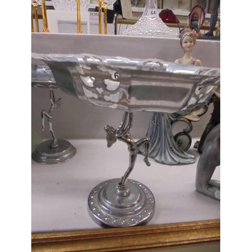 649 - Two metal cake stands with figural bases, a candlestick and a teapot.