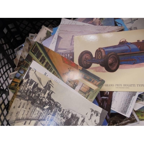 652 - A large mixed lot of old postcards and photographs.