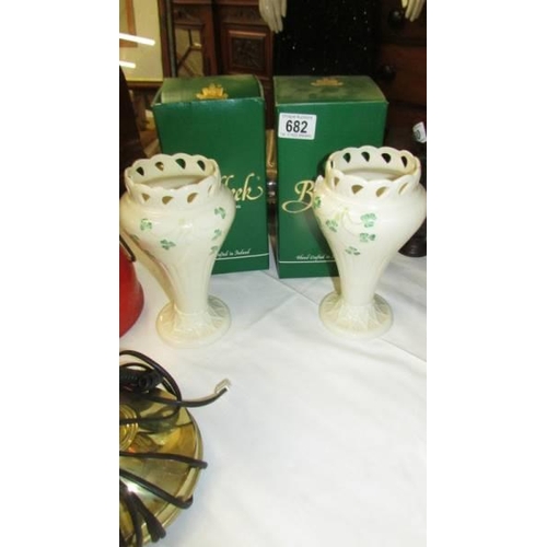 682 - A pair of boxed Belleek vases. (one has chip to rim).