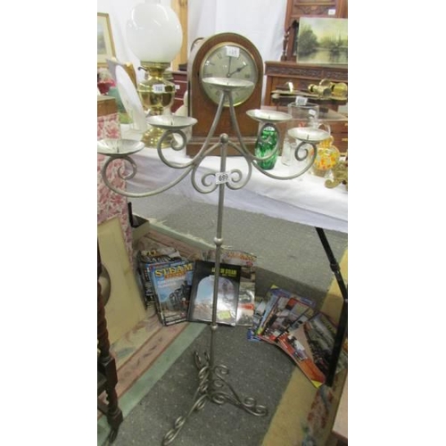 699 - A tall wrought iron scrollwork five branch candle stand, COLLECT ONLY.