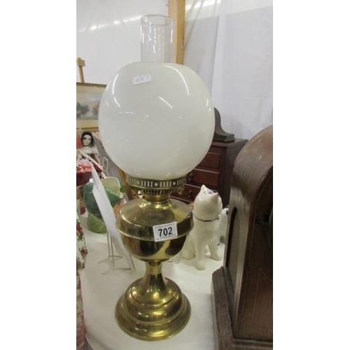 702 - An Edwardian brass oil lamp complete with shade, COLLECT ONLY.