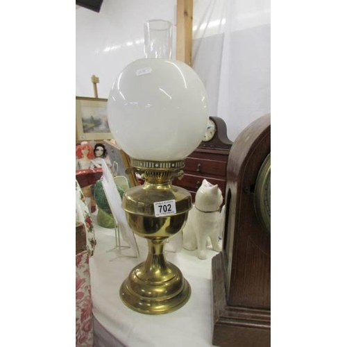 702 - An Edwardian brass oil lamp complete with shade, COLLECT ONLY.