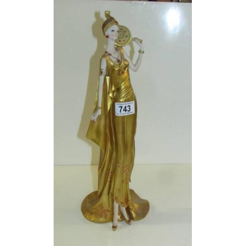 743 - An art deco style gilded figure.