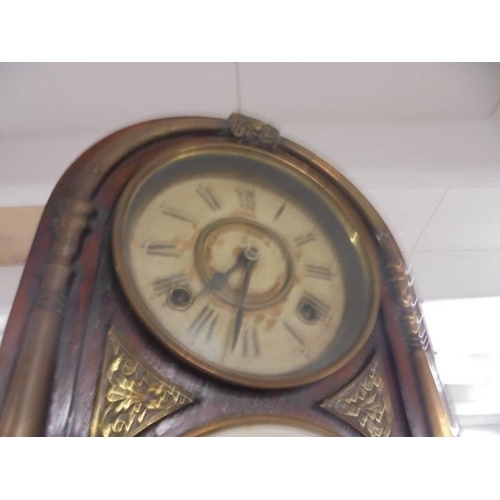 826 - An arched top brass mounted eight day mantel clock. COLLECT ONLY.