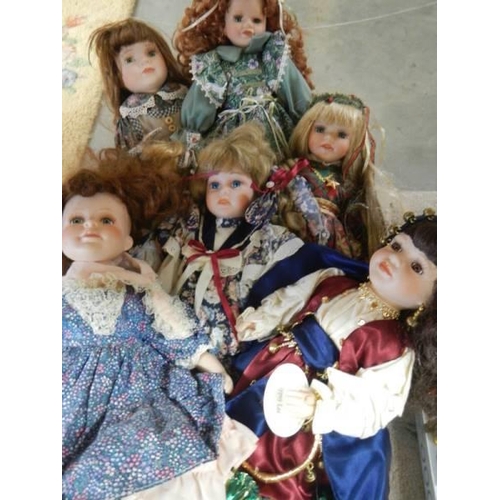 828 - A quantity of porcelain collector's dolls.