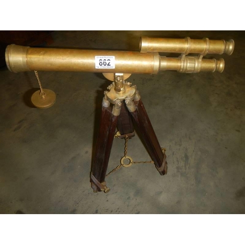 862 - A brass telescope on tripod for ornamental use only,