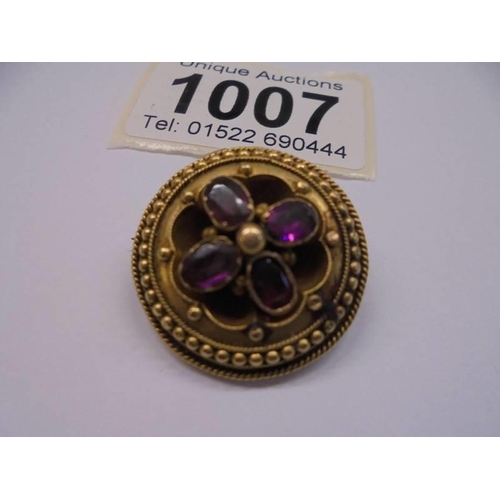 1007 - A Victorian yellow metal brooch set amethyst?